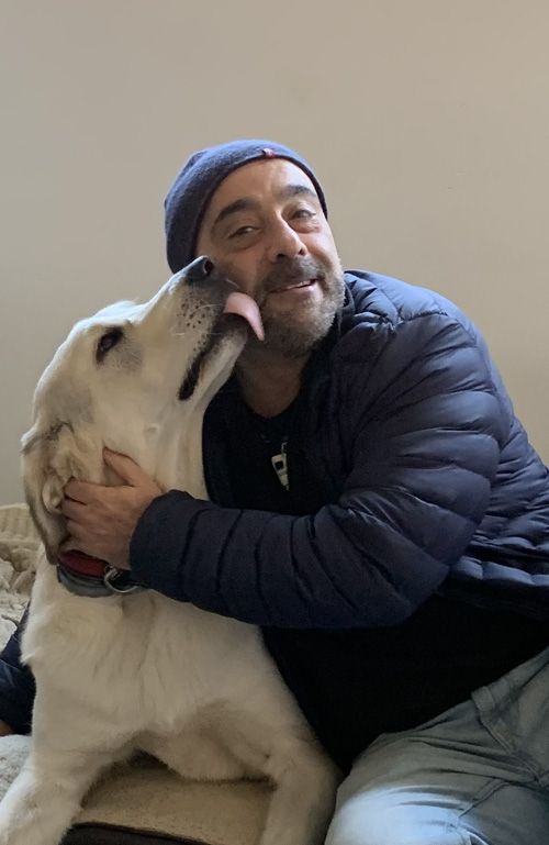 Un perro da un lametón cariñoso a su tutor